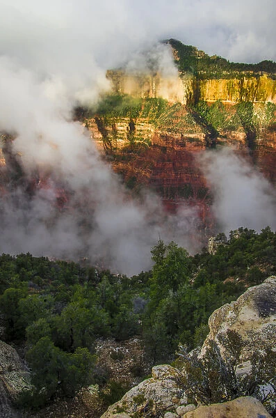 Clouds roll through the incredible rock formations of Bright Angel Point at the rugged