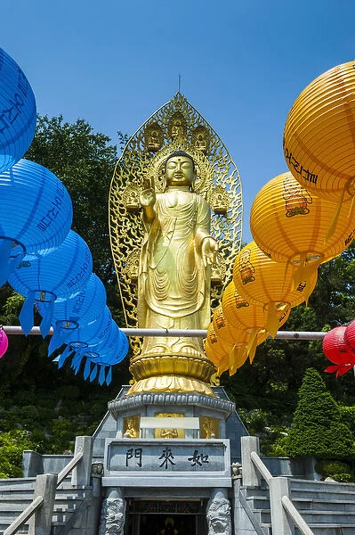 Colourful paper lanterns before a golden bussha in the Unesco world heritage sight