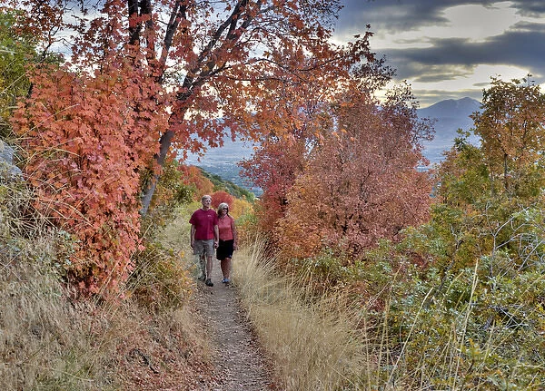 Couple on trail among fall foliage, above Bonneville Shoreline in Sandy, Uinta Wasatch