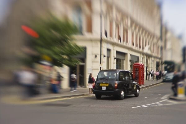 England, London. Black taxicab zooms through Londons streets