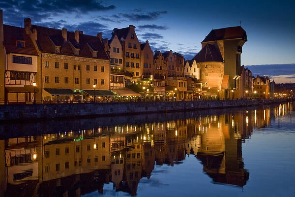 Europe, Poland, Gdansk. Buildings reflect in port water at sunset