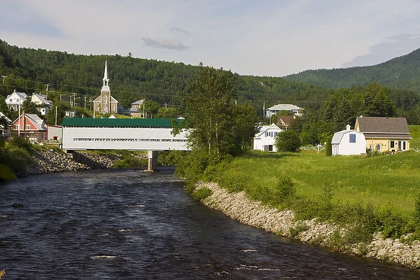Fauberg covered bridge and the village of l Anse St. Jean in the Saguenay River