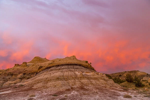 Fiery sunrise clouds over badlands at dawn in Theodore Roosevelt National Park, North Dakota