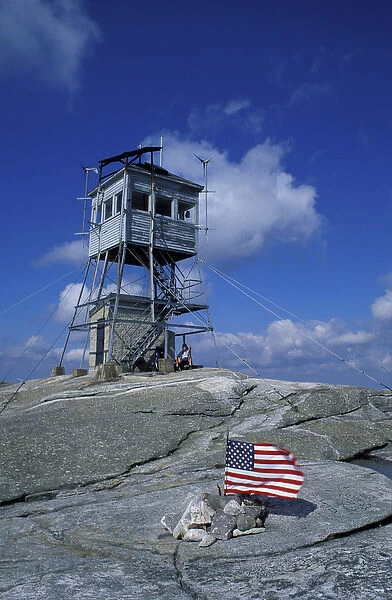 The fire tower on the summit of Mt. Cardigan in Mt. Cardigan State Park. American flag