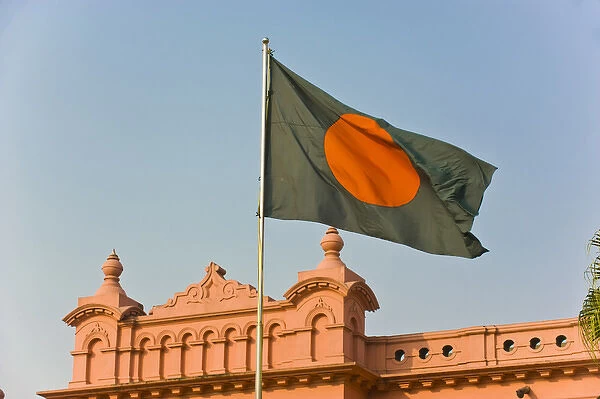 Flag of Bangladesh before the pink coloured Ahsan Manzil palace in Dhaka, Bangladesh