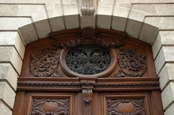 03. France, Avignon, Provence, ornately carved wooden doors with oval iron work 
