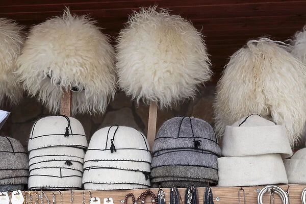 Georgia, Mtskheta. A collection of traditional hats for sale as souveniers
