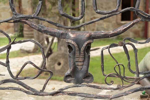 Georgia, Mtskheta. An decorative bull head on a metal fence