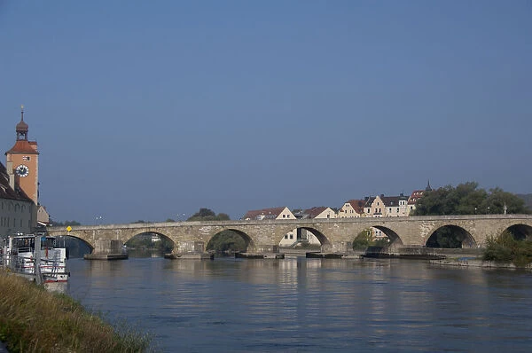 Germany, Bavaria, Regensburg. Historic 12th century Old Stone Bridge over the Danube
