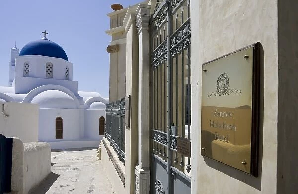 Greece, Santorini. Zannos Melathron Hotel with Greek Orthodox church in background