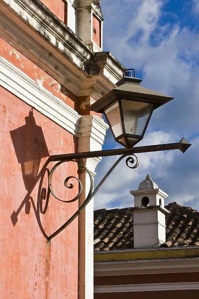 Guatemala, Antigua. Lantern on a street corner building in the town of Antigua