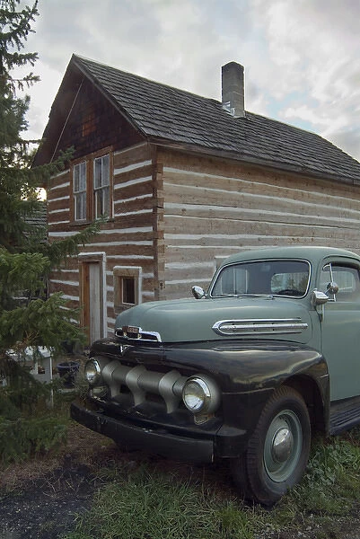 Historic log cabin and antique Ford pick up on the property of Summerhill Pyramid Winery