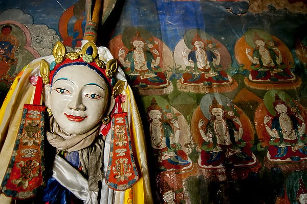 India, Jammu & Kashmir, Ladakh, a religious statue in front of a mural of repetitive