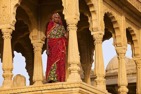 India, Rajasthan, Jaiselmer. Rajasthani woman stands at one of Tombs of the Concubines