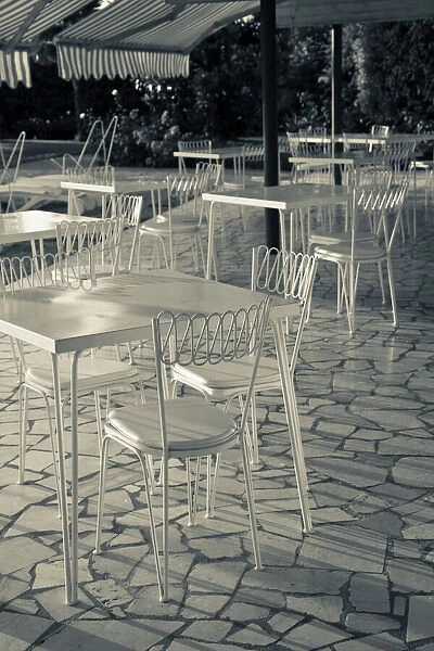 Italy, Brescia Province, Sirmione. Lakeside cafe tables
