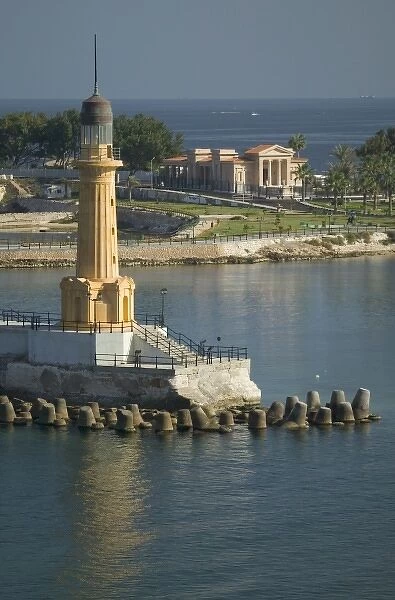 Lighthouse along the Jetty in Alexandria with a small harbor along the Mediterranean Sea, Egypt