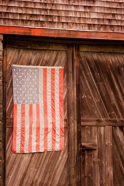 Maine, Faded American flag on door of old barn