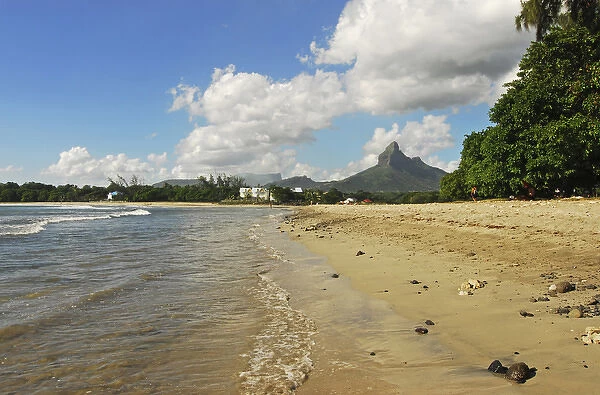 Mauritius, Tamarin, view of calm beach with trees and mountain peak in the background