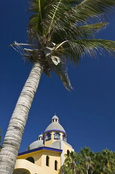 Mexico, Sinaloa State, Mazatlan. Palm and House on Playa Olas Altas Beach