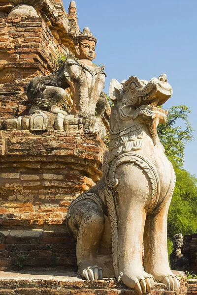 Myanmar. Mandalay. Inwa. Red brick stupa. Lion guardian