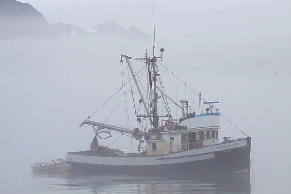 North America; USA; Alaska; Valdez; Fishing Boat in Fog with Mountains in Background