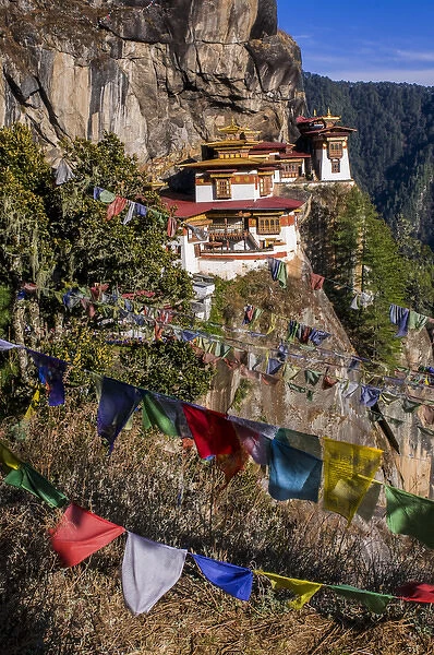 Praying flags before the Tiger-Nest, Taktshang Goempa monastery hanging in the cliffs