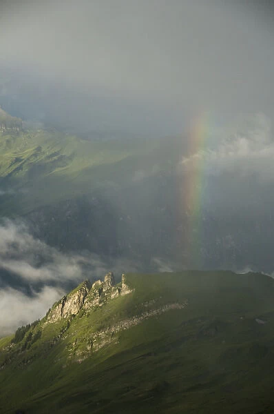 Rainbow over slopes below Faulhorn, Bernese Oberland, Switzerland ALPS
