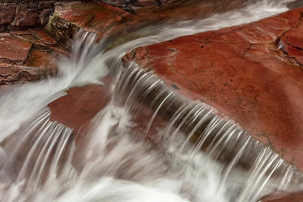 Red rocked bottom of Virginia Creek in Glacier National Park, Montana, USA