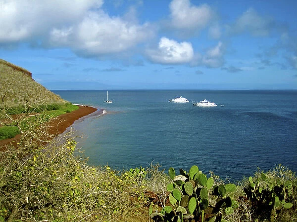 A sailboat and yachts with tourists along Coastline of the Galapagos Islands of Ecuador