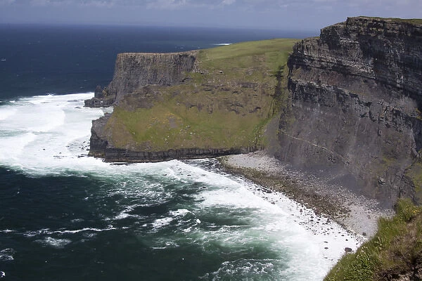 Scenic Cliffs of Moher and beach with the Atlantic Ocean and choppy waves