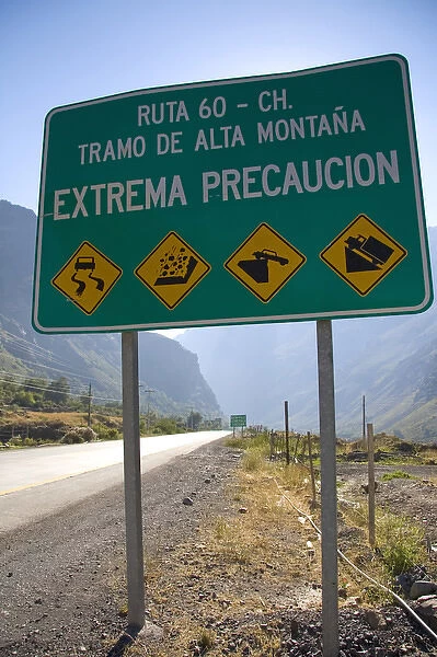 Spanish language road sign warning of hazardous road conditions at the foot of the