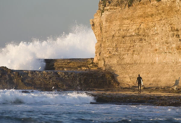 Surfer sizing up the challenge. Santa Cruz coast, California, US