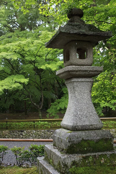 A traditional Japanese lantern marks the path towards the Golden Temple (Kinkaku-Ji) in Kyoto