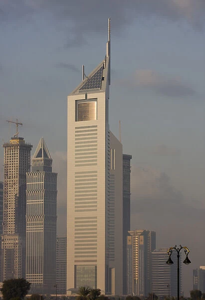 United Arab Emirates, Dubai. Emirates Towers and The Tower in morning light. Credit as
