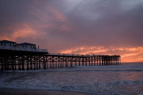 US, CA, San Diego. The sun sets over Crystal Pier in San Diego with brilliant clouds overhead