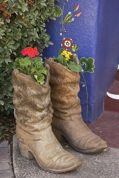 USA, Arizona, Tucson. Cowboy boots used as planters on porch of Hacienda Del Sol Guest Ranch Resort
