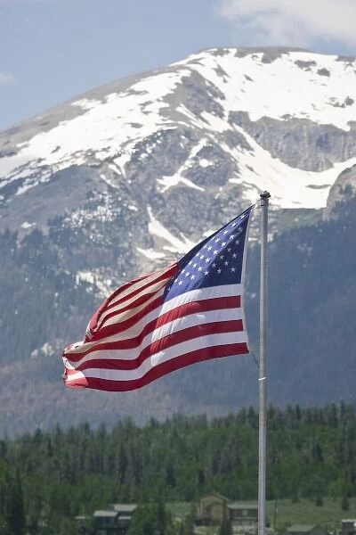 USA, Colorado, Silverthorne. American flag flying against mountain backdropFred J