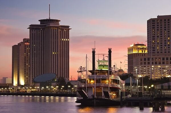 USA, Louisiana, New Orleans. World Trade Center, riverboat and Mississippi Riverfront, dusk