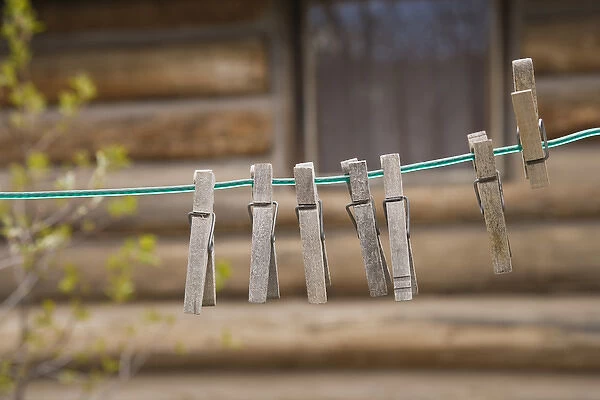 USA, Montana. Clothes pins on a clothesline outside log cabin
