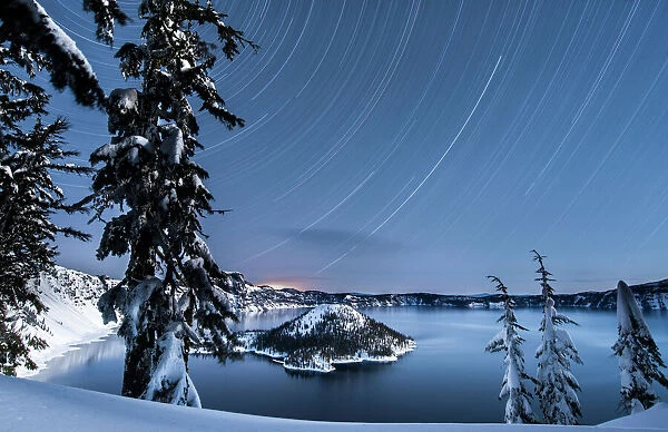 USA, Oregon, Crater Lake National Park. Star trails over Crater Lake and Wizard island in winter