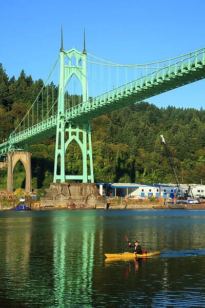 USA, Oregon, Portland, Cathedral Park, kayaker paddling under the St. Johns Bridge