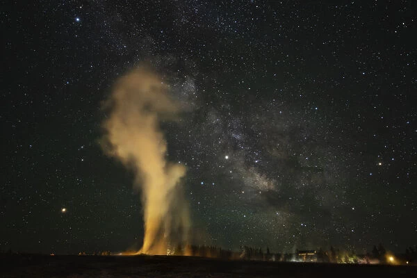 USA, Wyoming, Yellowstone National Park. Milky Way and erupting Old Faithful Geyser