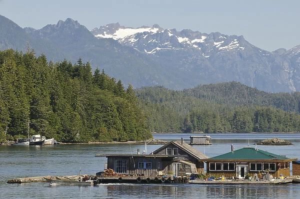 Vancouver Island, Tofino. Floating houses in front of mountains of Strathcona Provincial