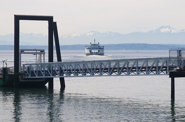 Washington State ferry arriving at terminal in downtown Seattle. Olympic Mountains