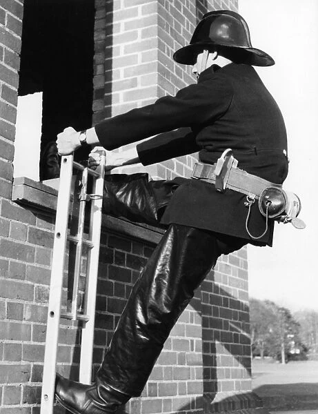 Firefighter during hook ladder practice