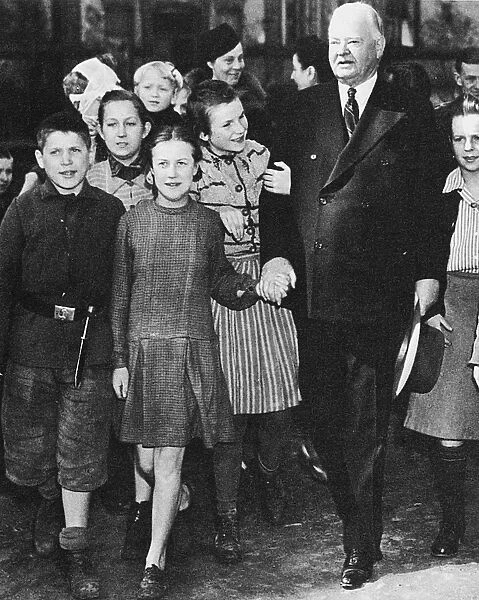 31st President of the United States. Photographed with children in Poland, 1946, while serving as U. S. director of postwar relief