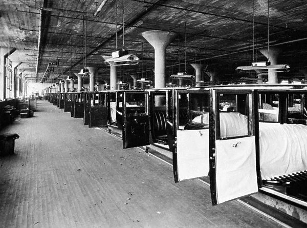 AUTOMOBILE ASSEMBLY LINE. An assembly line of Studebaker bodies. Photograph c1920
