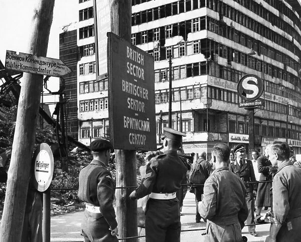 BERLIN, 1948. British military police erecting a sign to mark the division of British