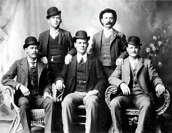 CASSIDY AND LONGBAUGH. Butch Cassidy (1866-?), alias of Robert Leroy Parker, American desperado, and Harry Longbaugh (1867-?), known as the Sundance Kid, American desperado. Cassidy (seated far right) and Longbaugh (seated far left) with members of their Wild Bunch, photographed at Fort Worth, Texas, in 1901