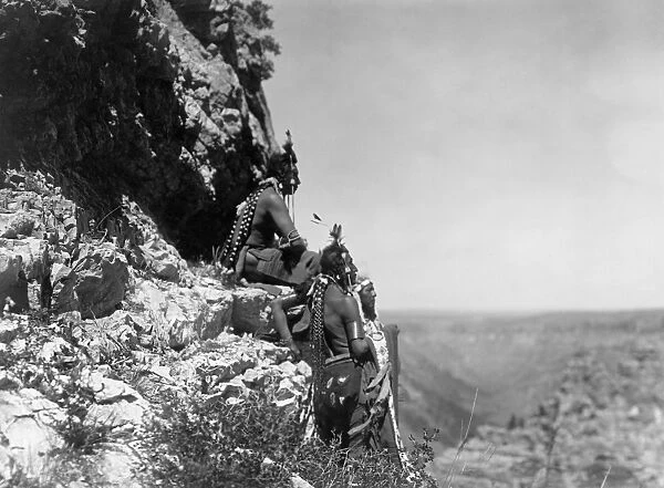 CURTIS: CROW MEN, c1905. Three Crow Native Americans standing on the edge of a cliff in Montana